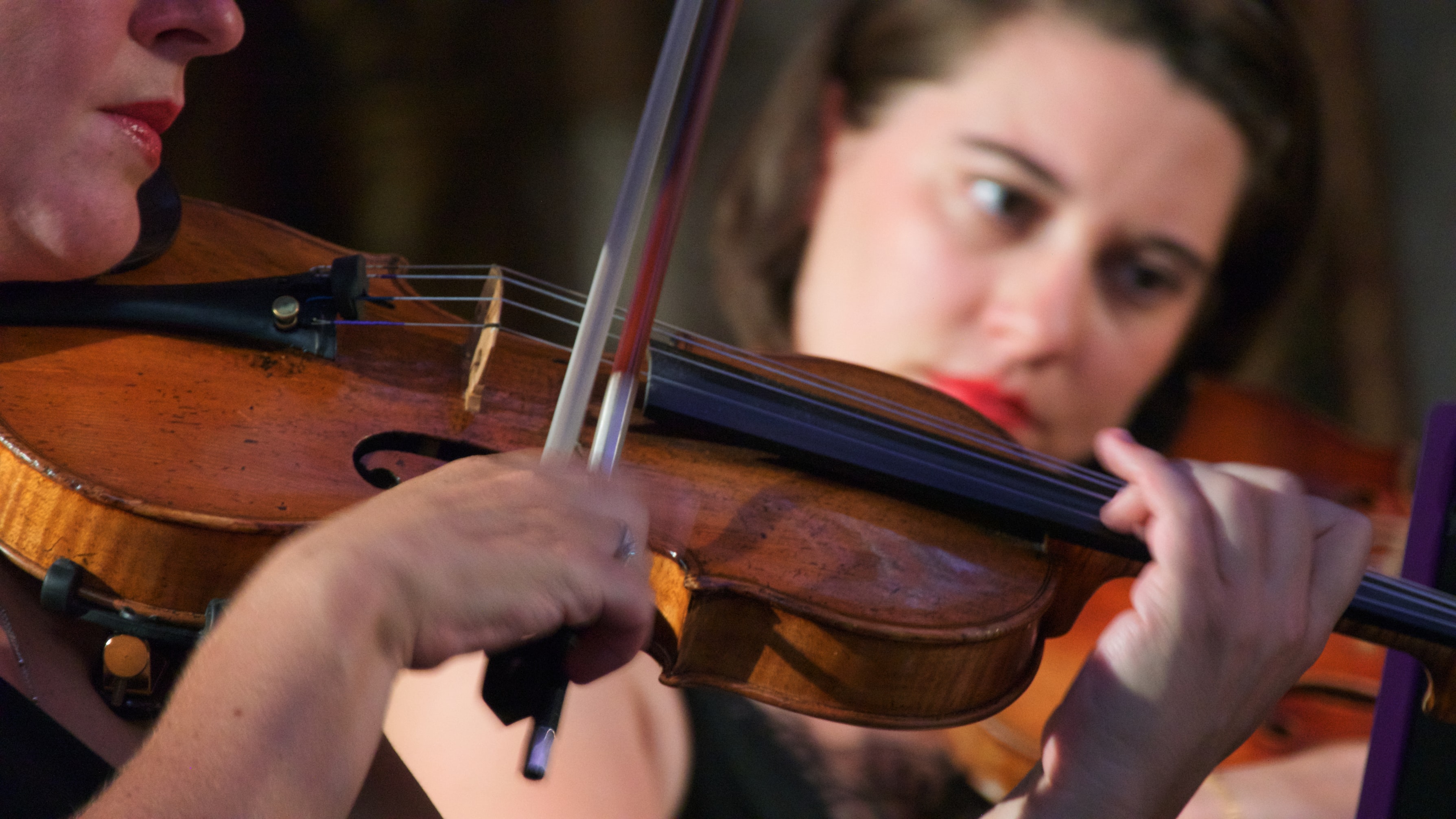 Woman playing violin close-up